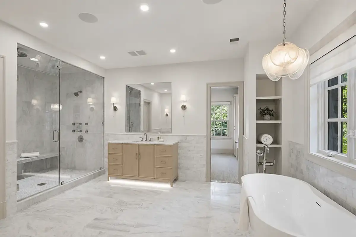 Ensuite bathroom with marble tiling, standing shower, separate footed tub of 4614 36th St N
