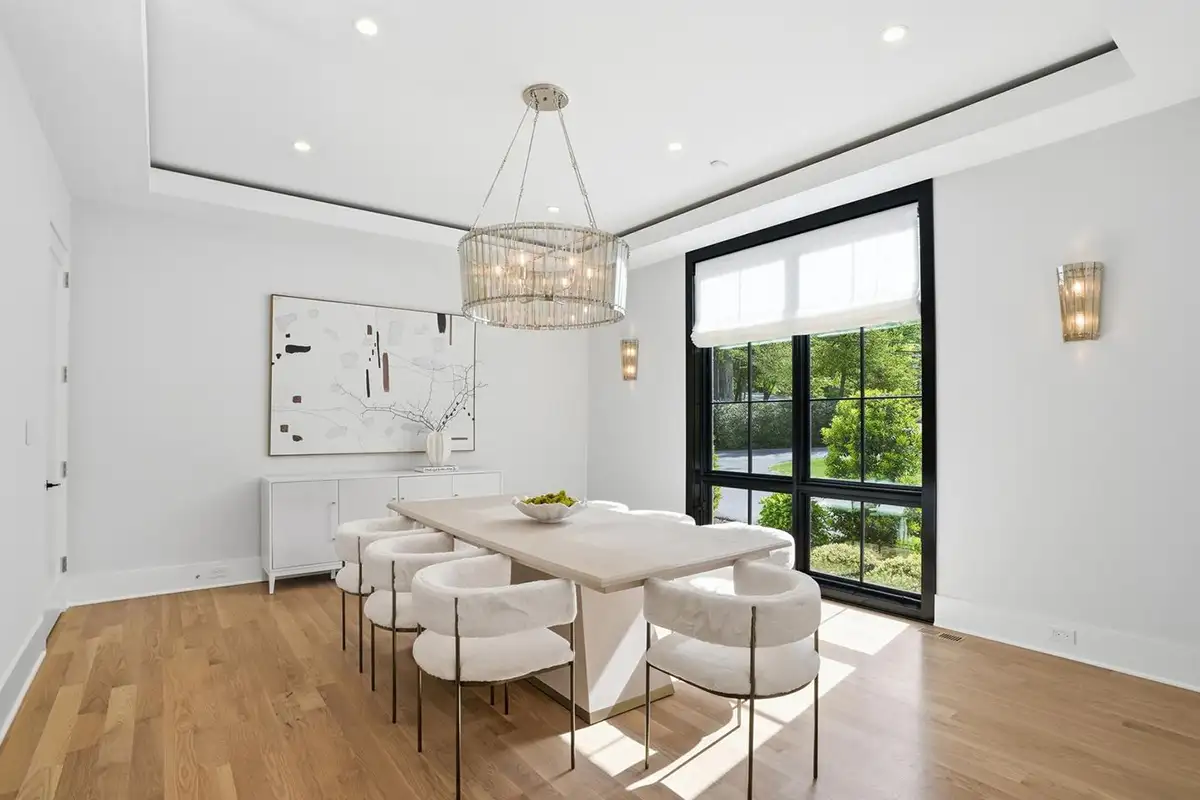 Dining room with hardwood floors, chandelier light fixture, and floor to ceiling windows of 938 Saigon Rd