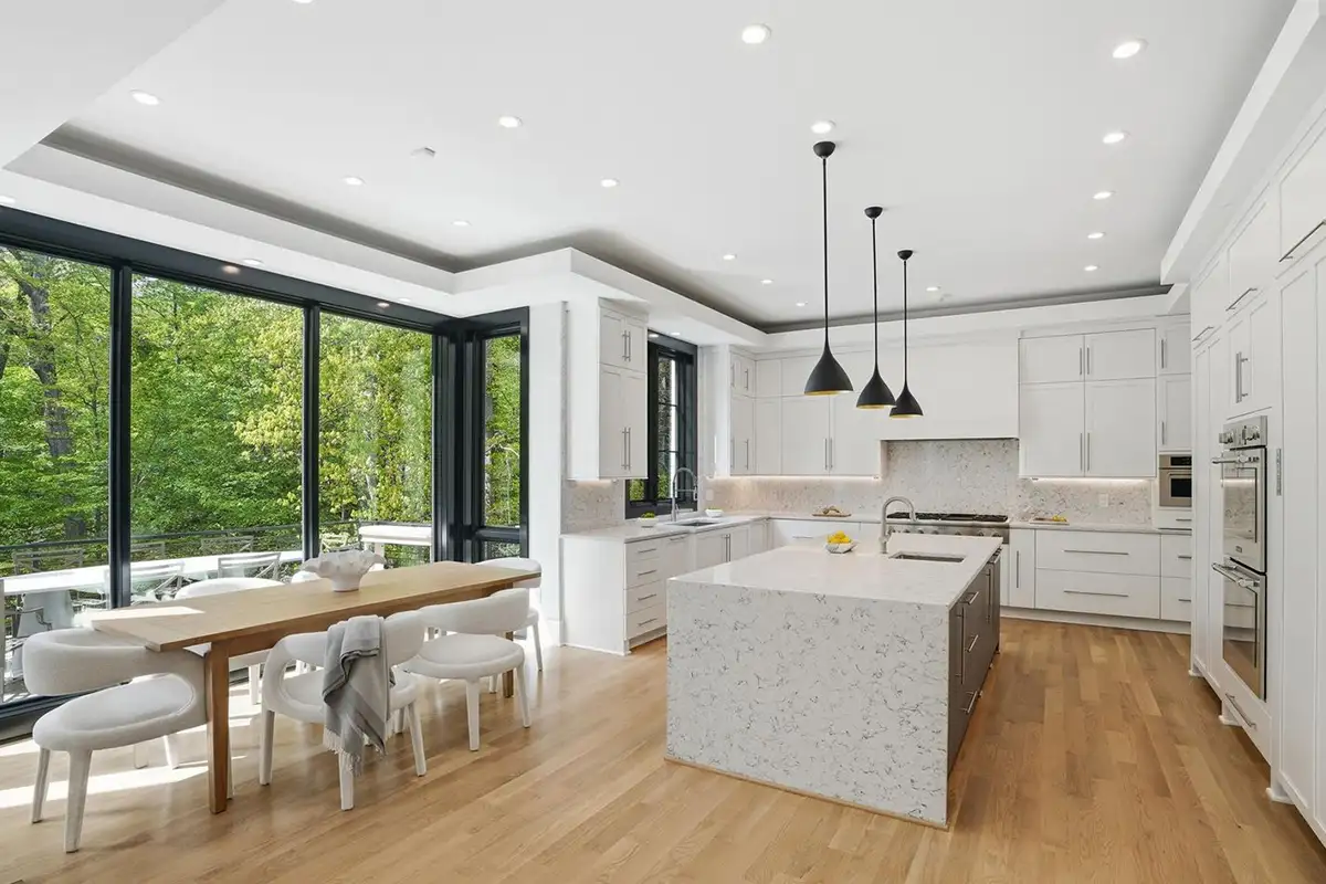 Kitchen and breakfast area with thermador appliances, quartz waterfall island, and customized beverage center of 938 Saigon Rd