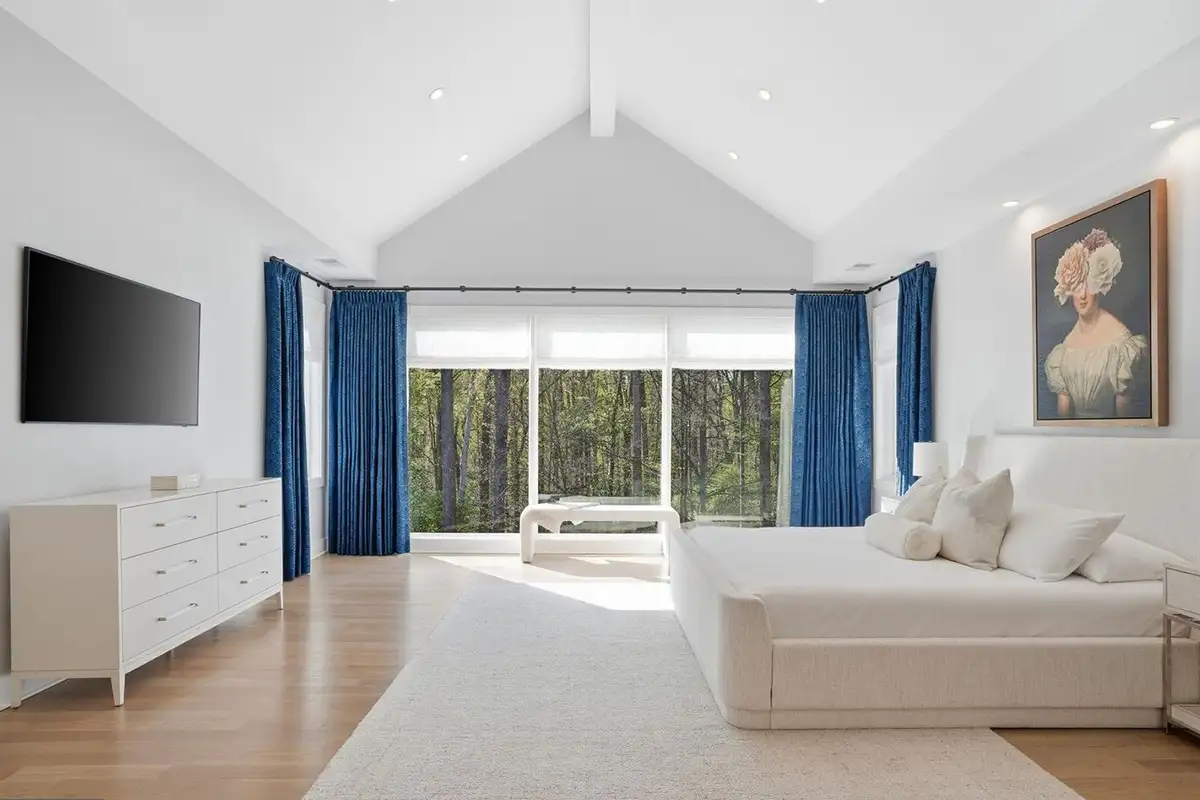 Primary bedroom with volume ceilings, large windows, and a fireplace of 938 Saigon Rd