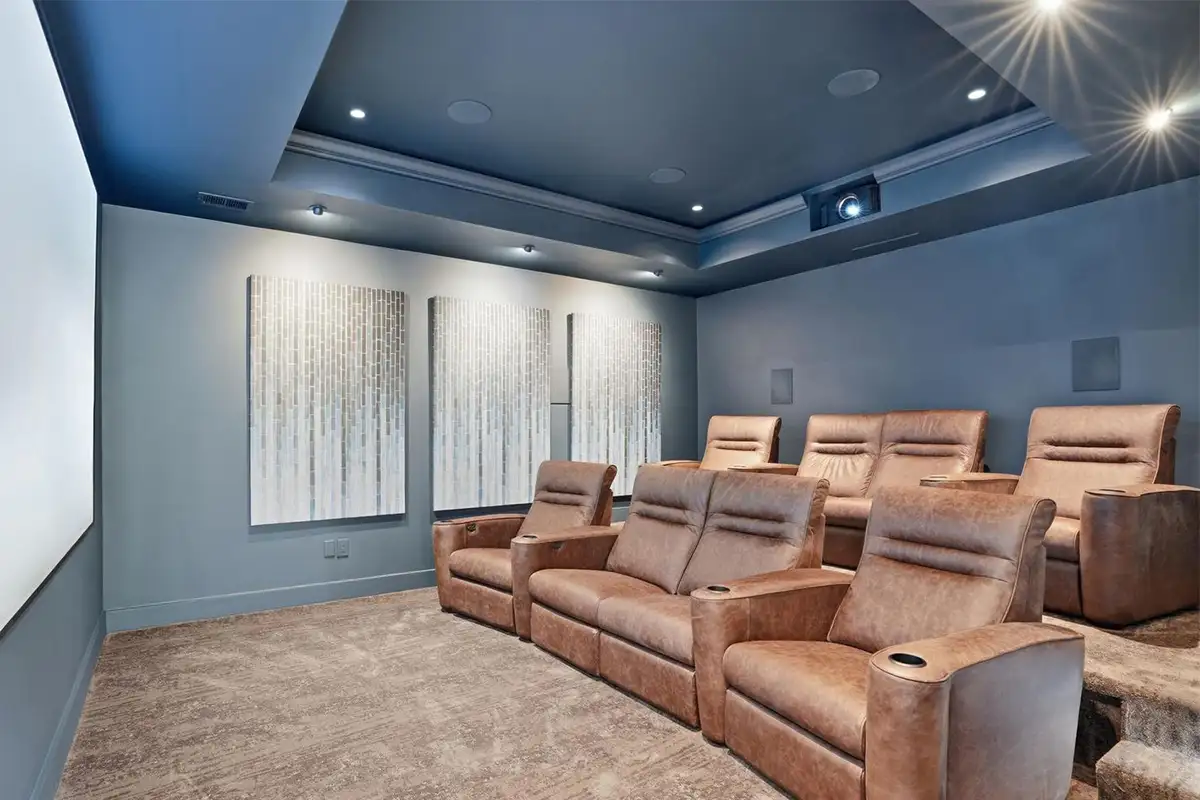 Home theater with leather chairs, projector, and carpeted floors of 938 Saigon Rd