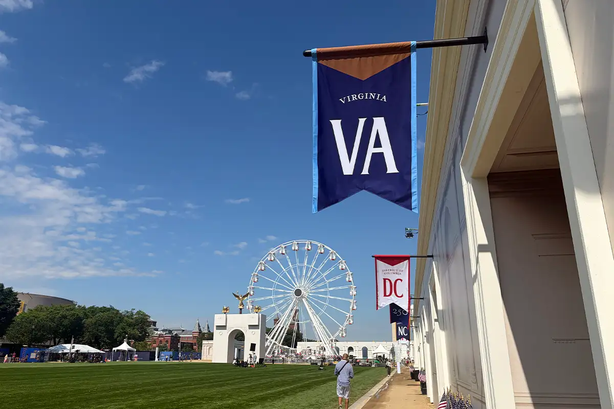 Great American State Fair in DC with Virginia booth flag and carousel in the background
