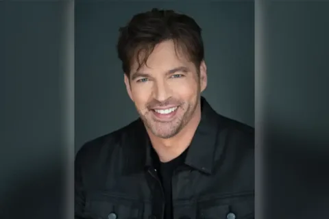 headshot of Harry Connick, Jr. in black shirt and jacket