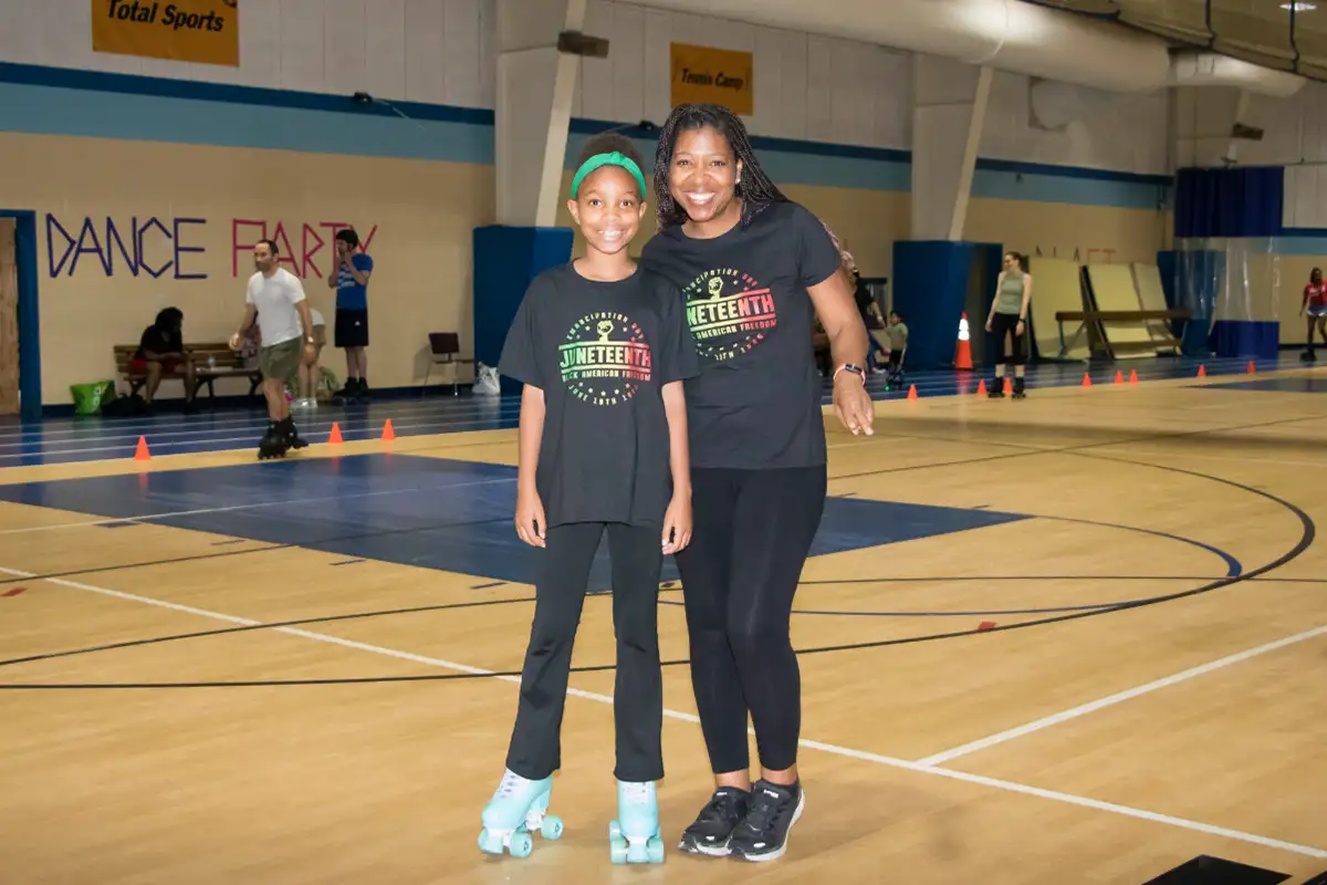 Mother and daughter skating at Family Skate and Dance Night for Juneteenth