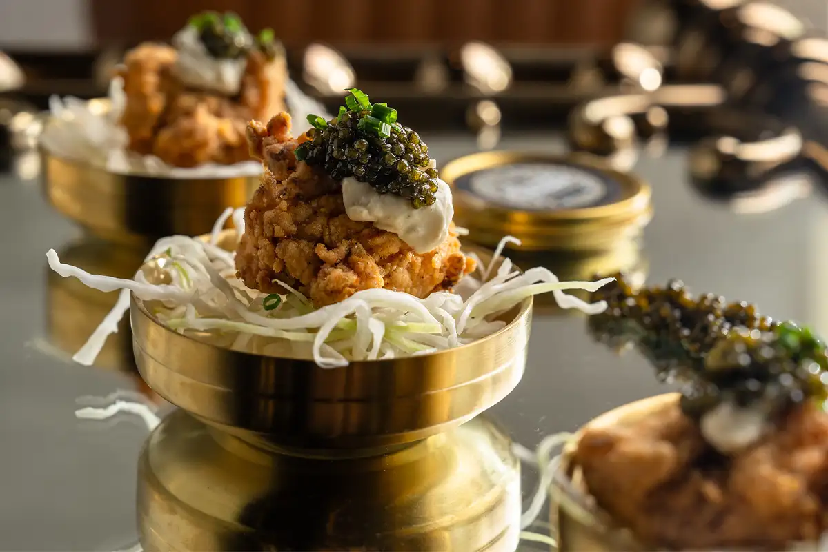 a chicken nugget with caviar at Little Birdie