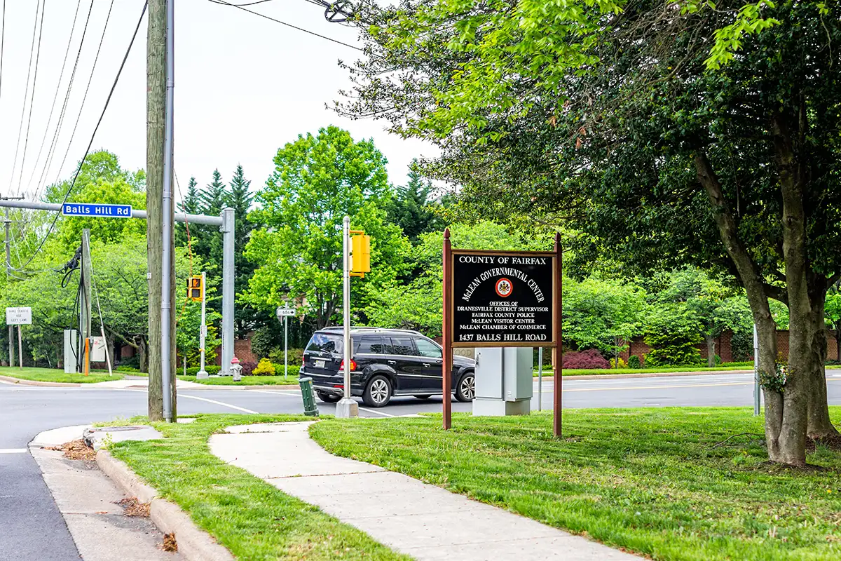 a car drives past the McLean Government Center sign