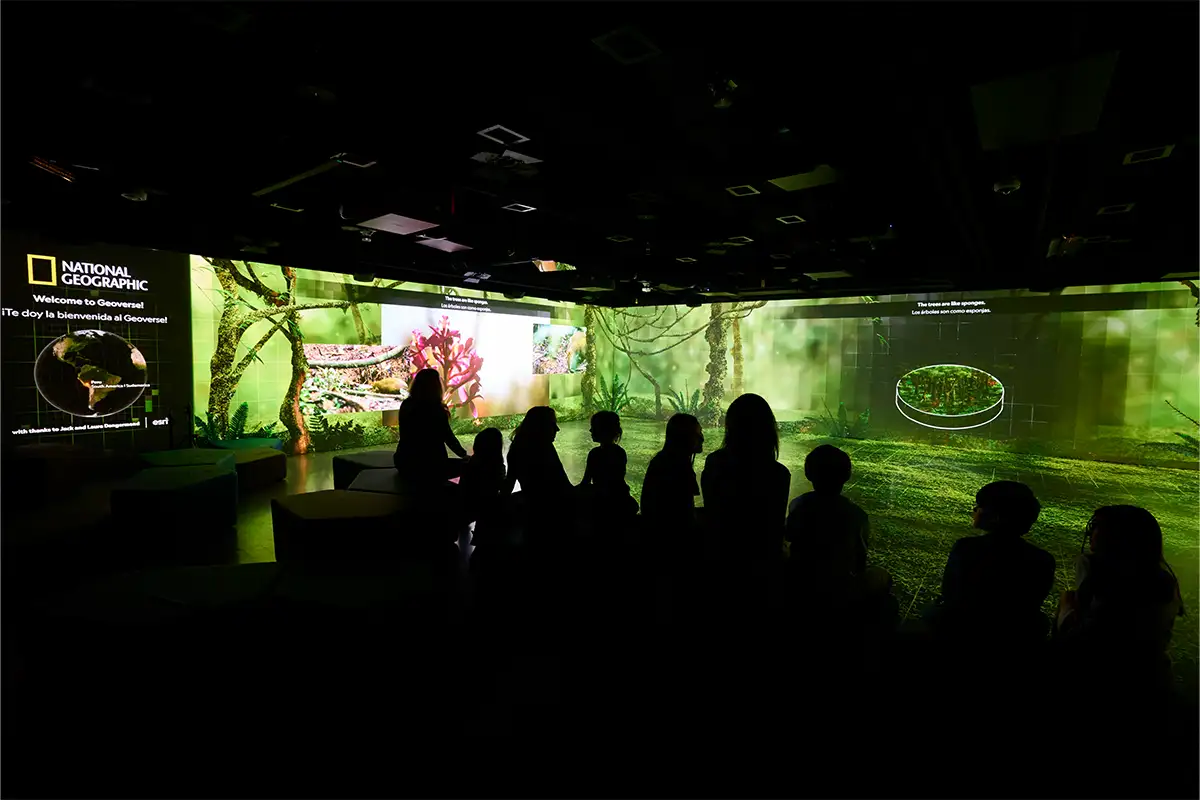 Kids sitting and watching Geoverse at the National Geographic Museum