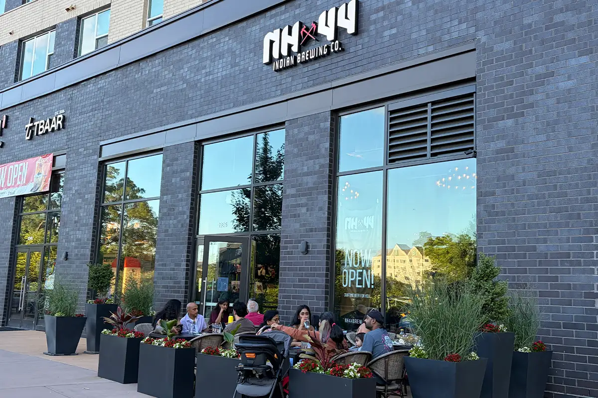 people sit at tables outside of NH44 Indian Brewing Company in Herndon