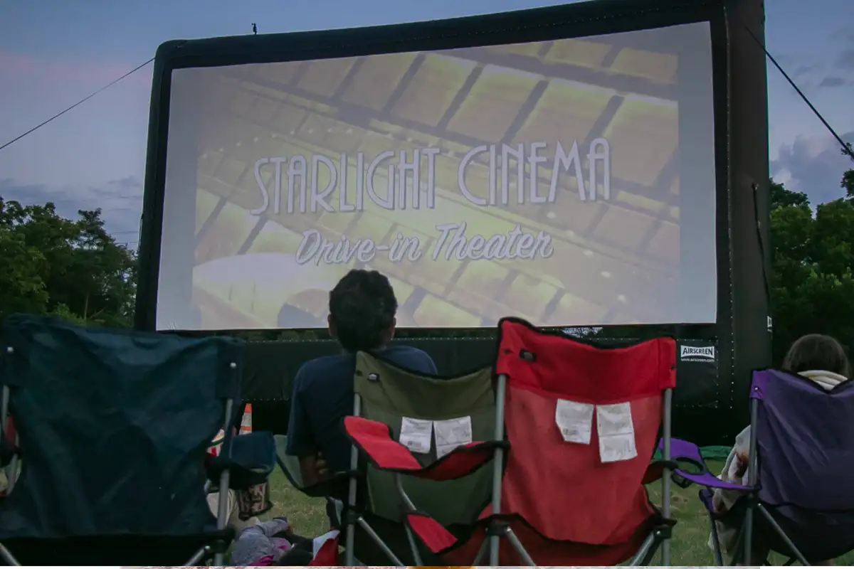 people sit in front of a drive-in movie screen at Sully Historic Site 