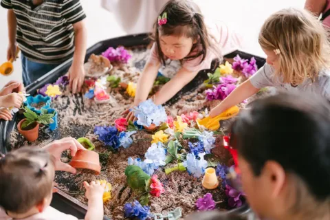 kids play with sand and materials on a table at SensePlay Studio