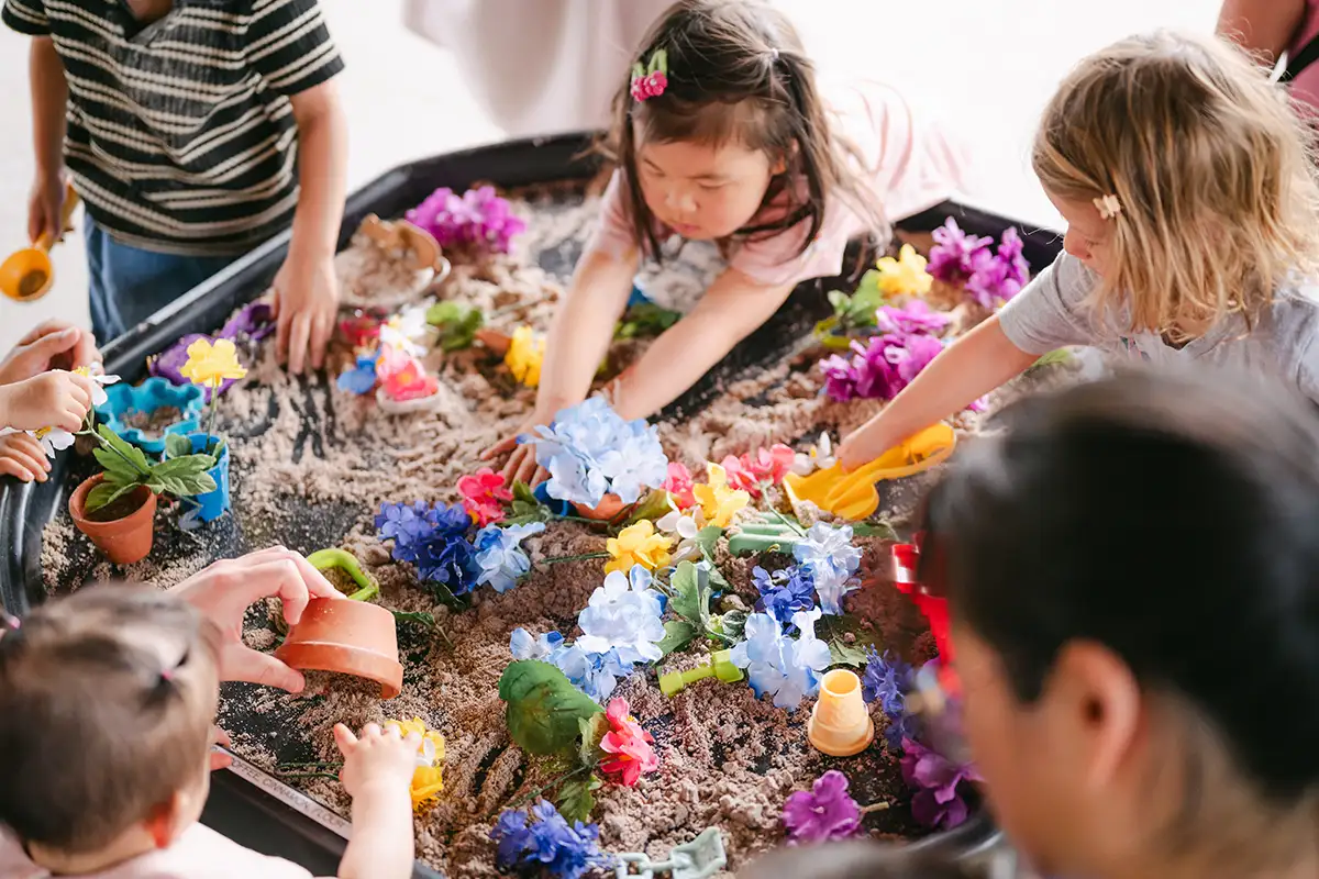 kids play with sand and materials on a table at SensePlay Studio