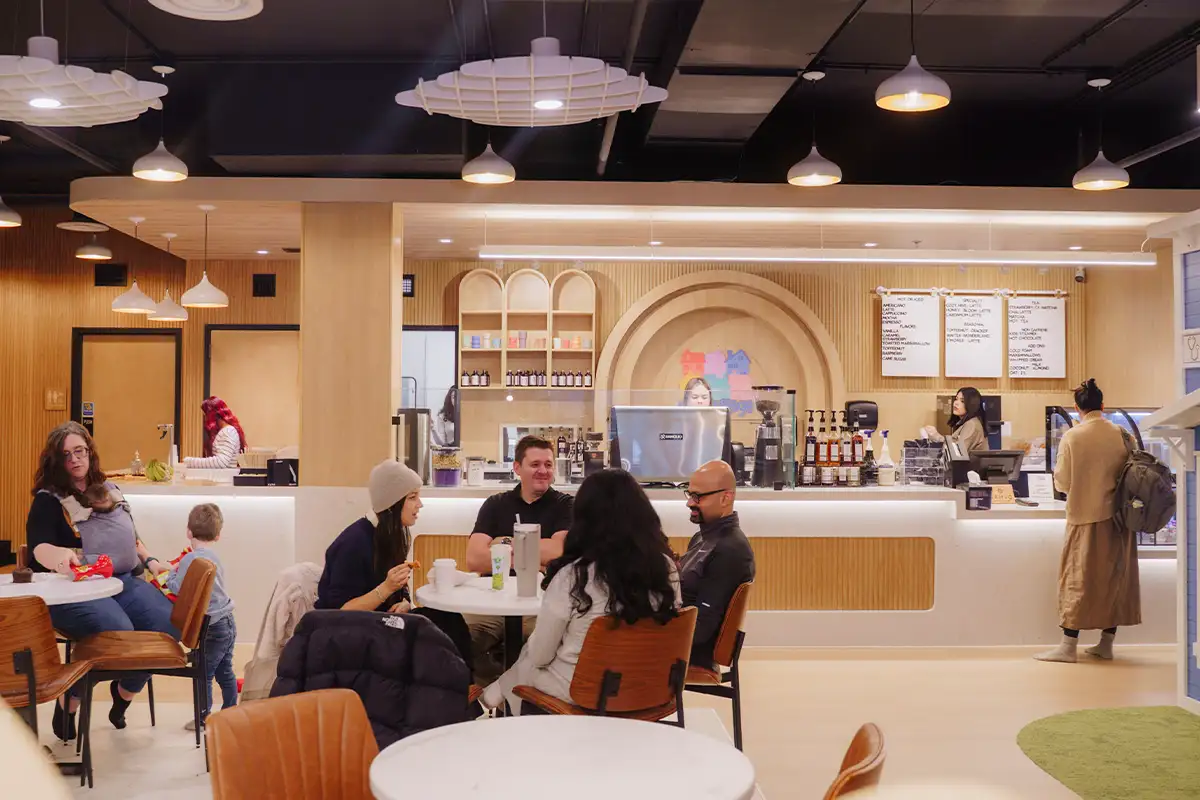 adults sit at the cafe at Cozy Village Play Café