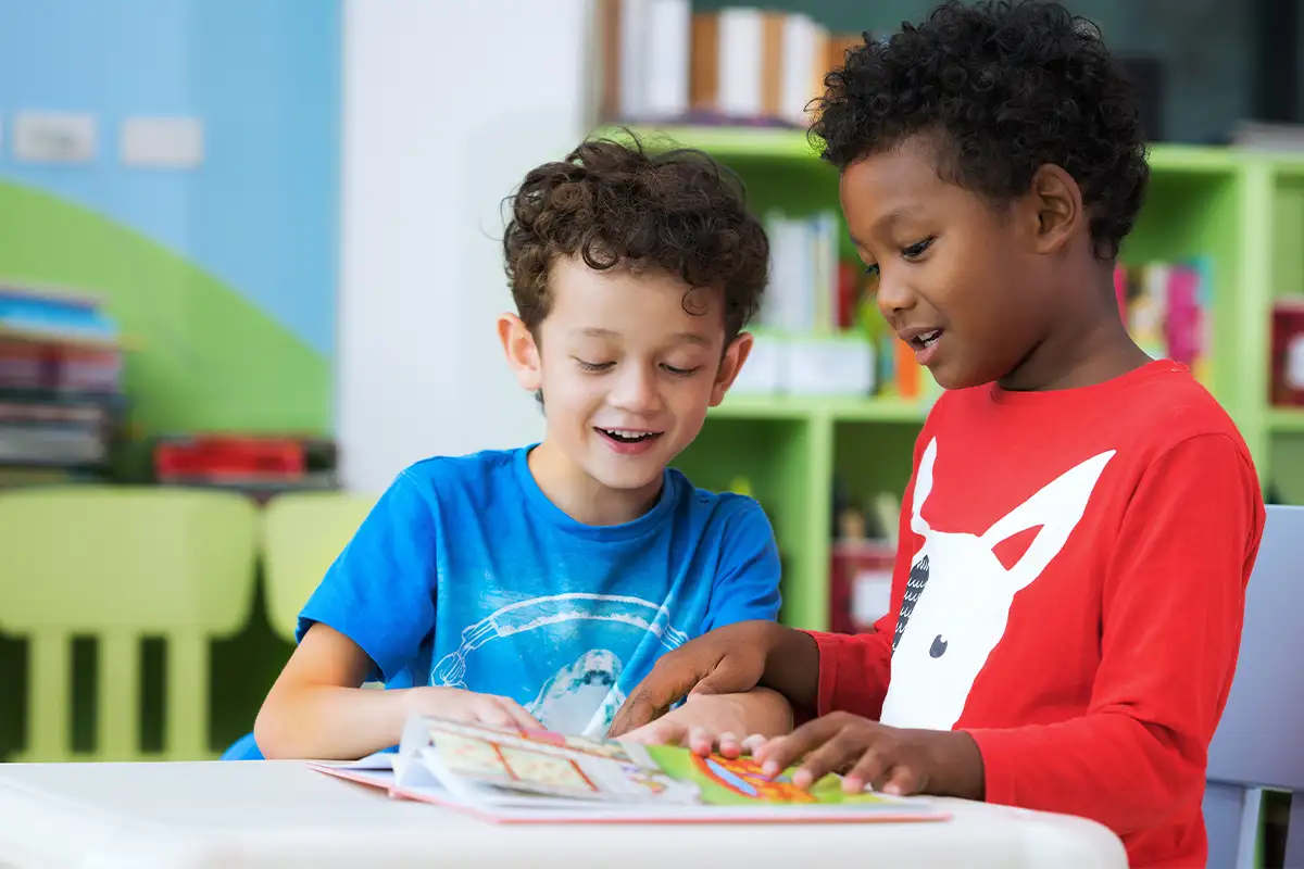 two boys reading a book