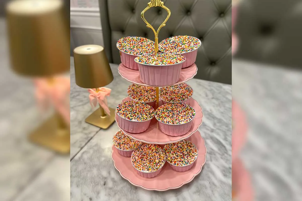 tiered pink platter holding dot cakes