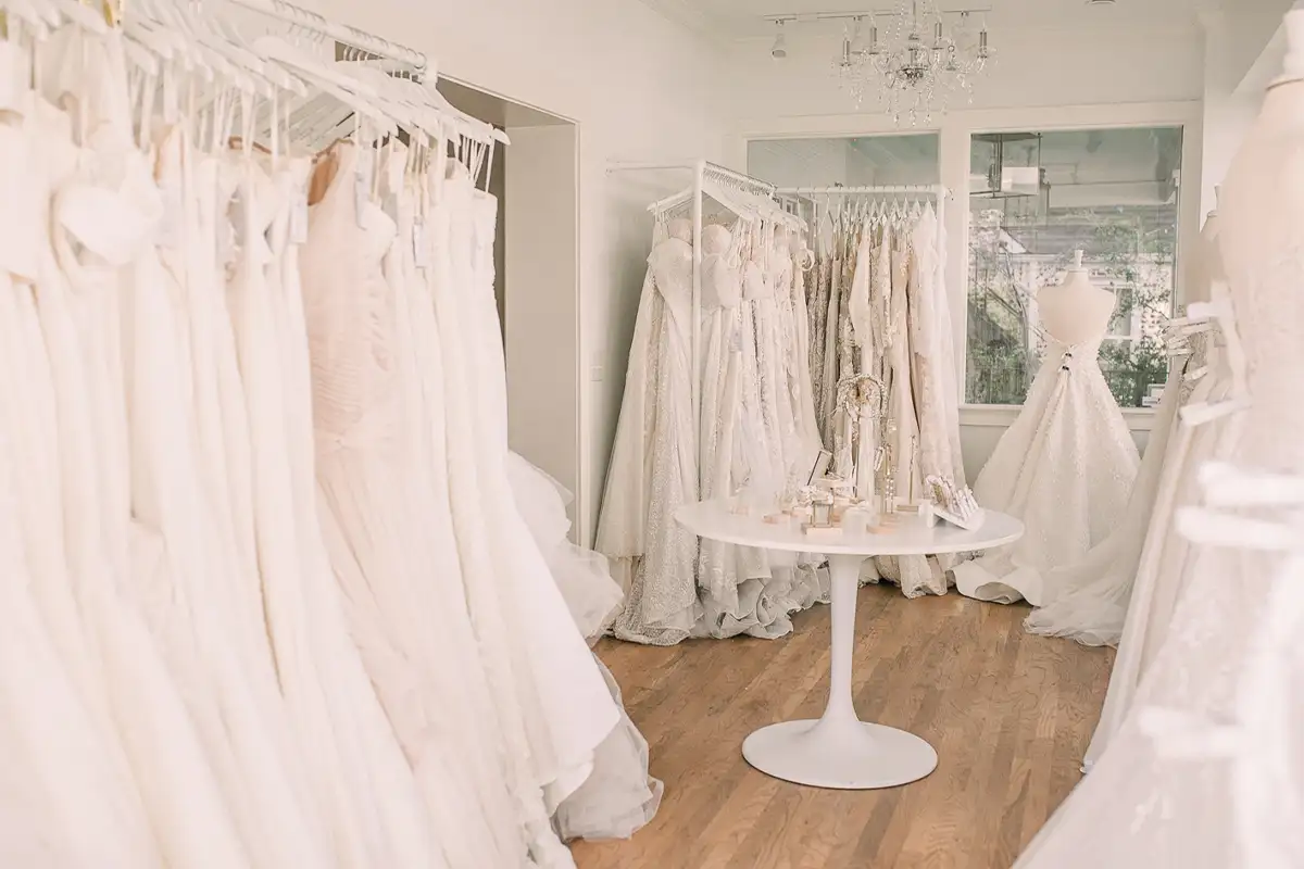 wedding dresses hanging on racks at The White Magnolia Bridal Collection