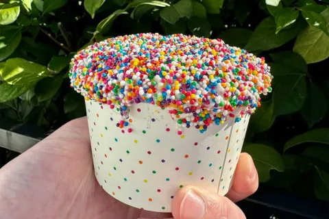 hand holding swirlies dot cake sundae