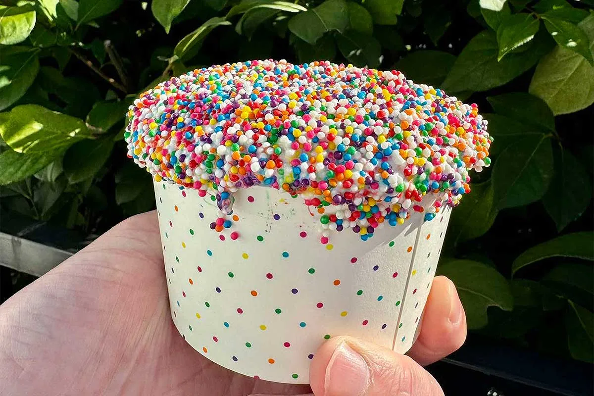 hand holding swirlies dot cake sundae
