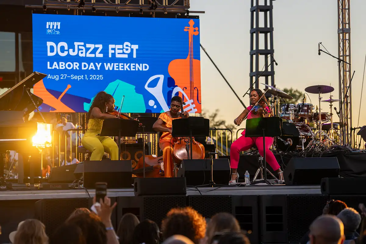 Three women playing violins and cellos on stage at DC Jazz Fest