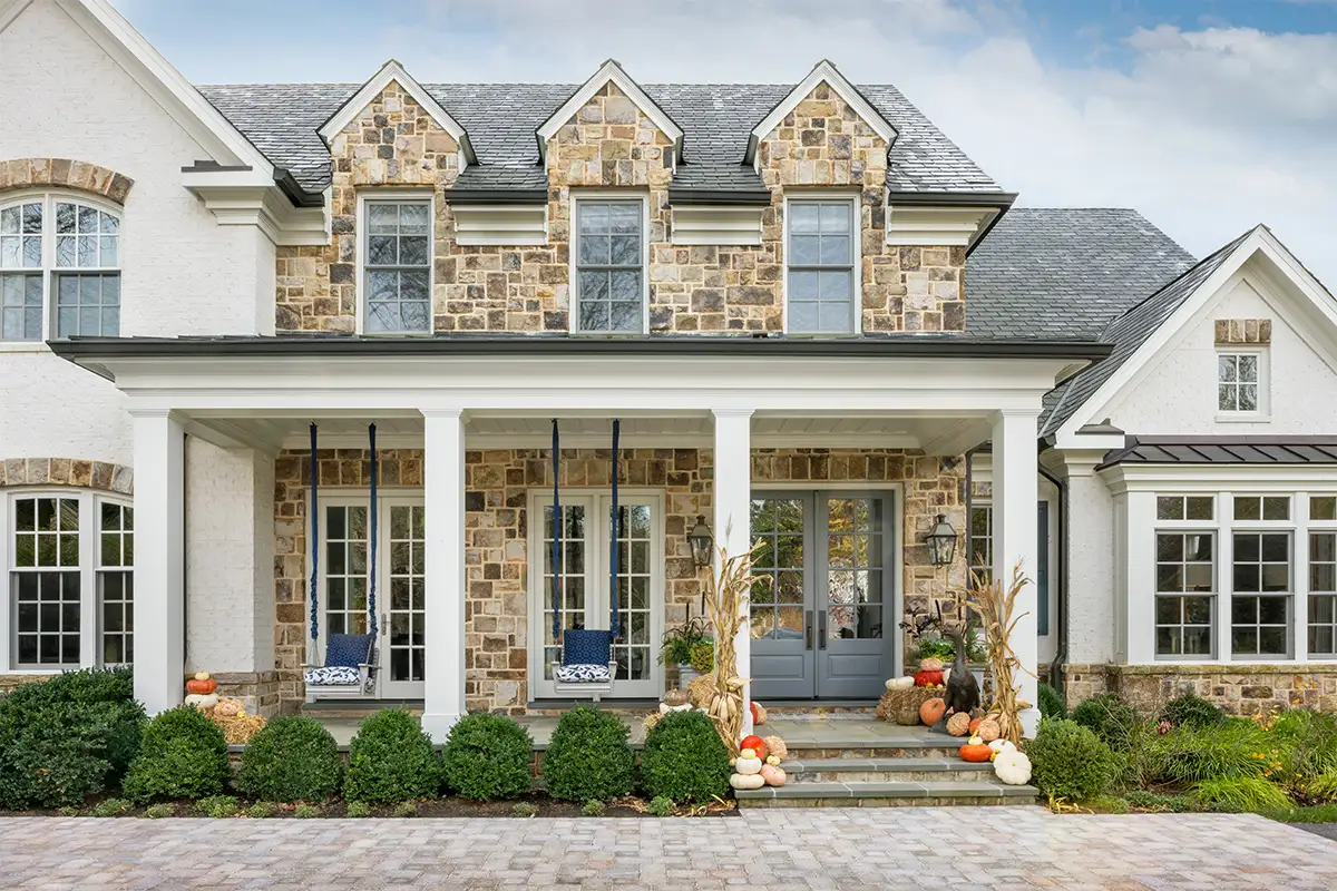 Exterior of stone McLean house with blue porch swings
