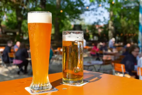 Two glasses of beer on table outside