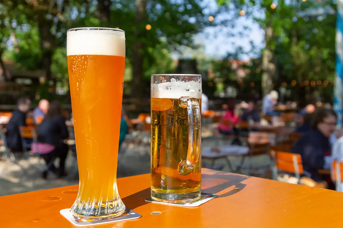 Two glasses of beer on table outside