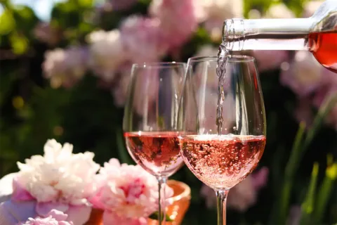 Wine being poured into a glass outside