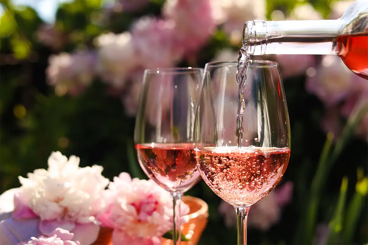 Wine being poured into a glass outside