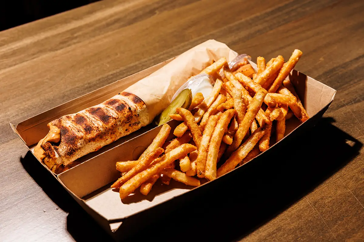 Chicken sandwich with fries dish by Tio Pelé