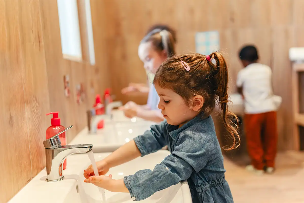 Little girl washing her hands