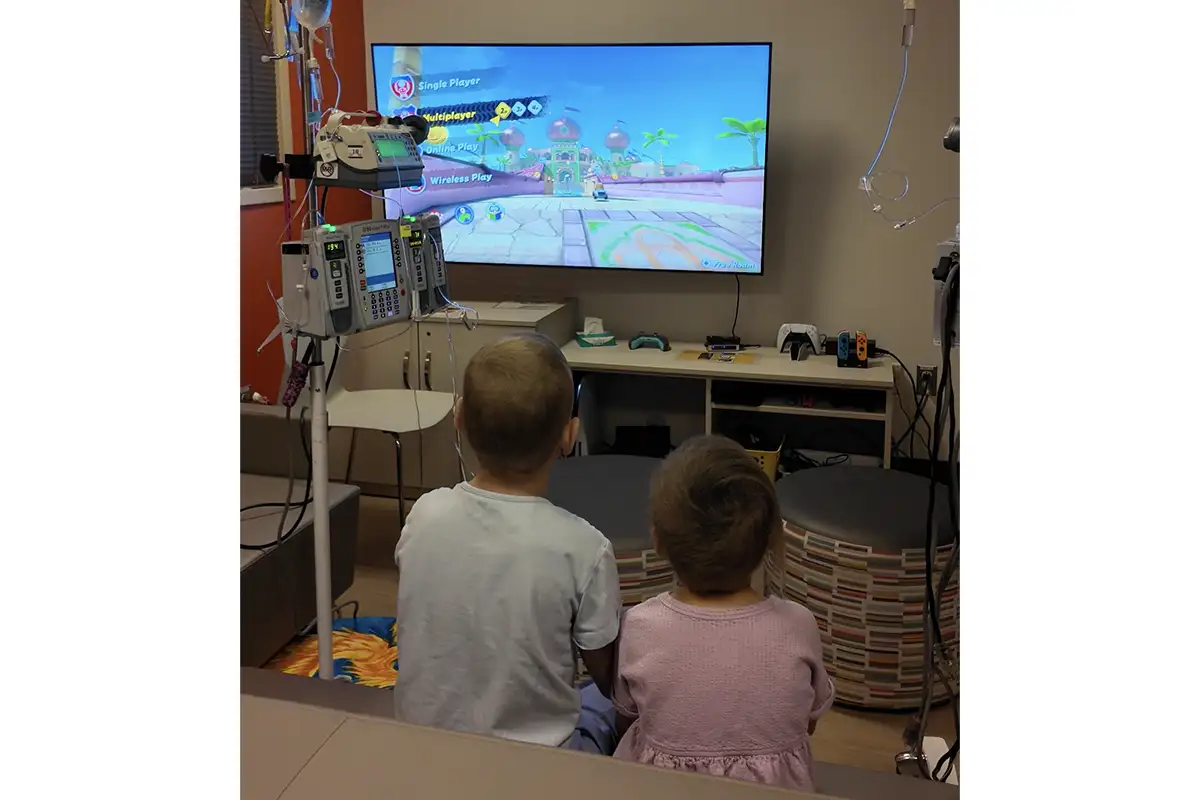 two kids playing video games in hospital