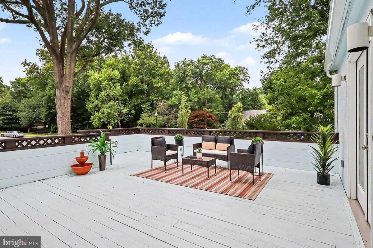 light blue deck with patio furniture overlooking N. Nicholas St.