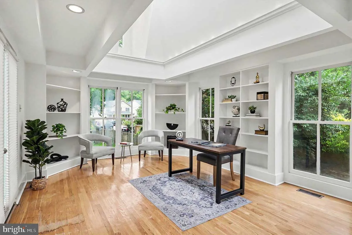 office space with floor-to-ceiling windows and skylight
