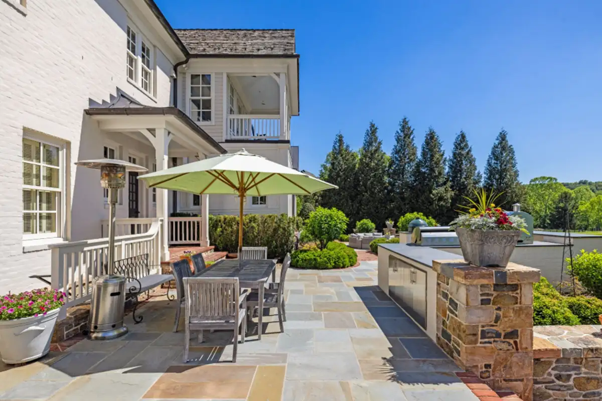 Outdoor patio area with kitchen, grill, oven, smoker, and seating areas of 22364 Wilson Meadows Ln