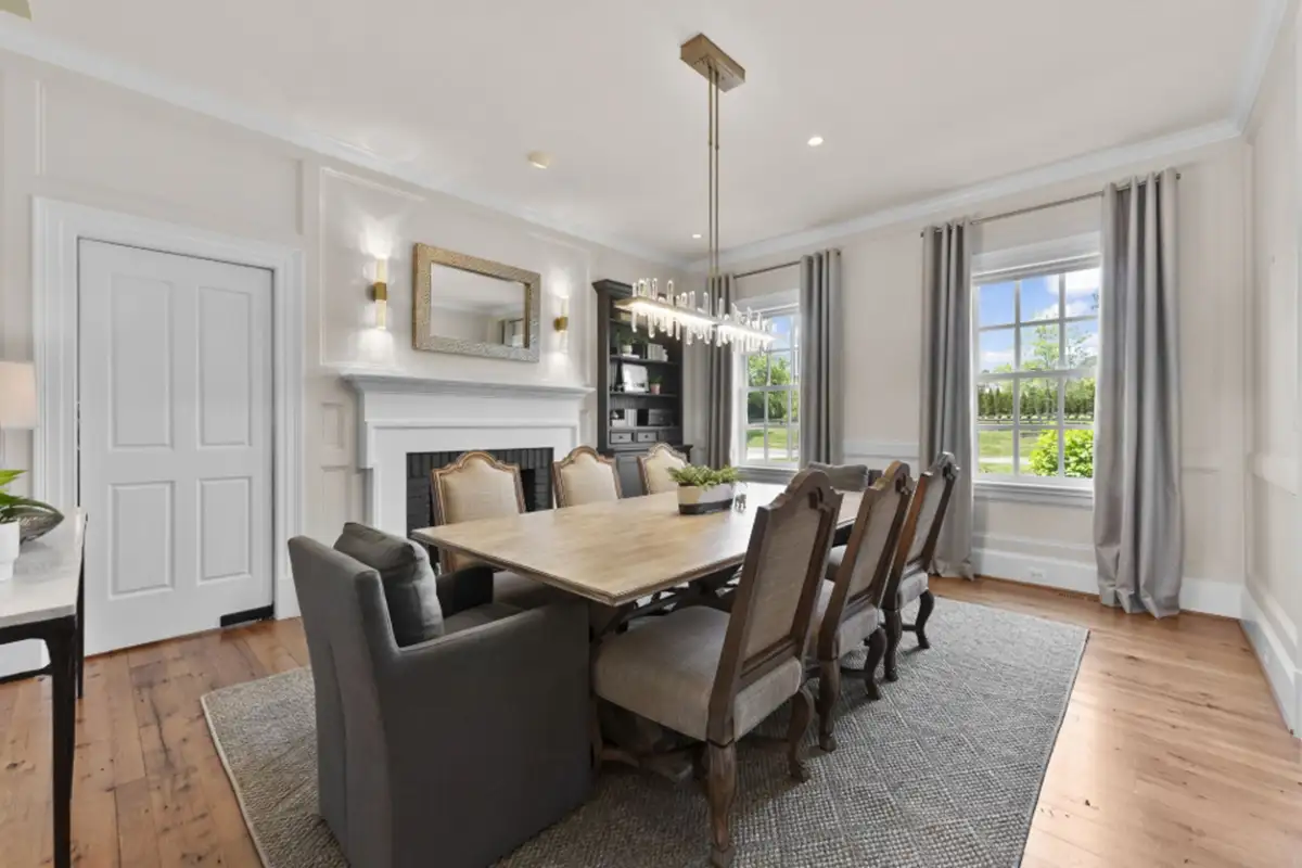 Dining room with a fireplace, wainscoting, and built-in bookshelf of 22364 Wilson Meadows Ln