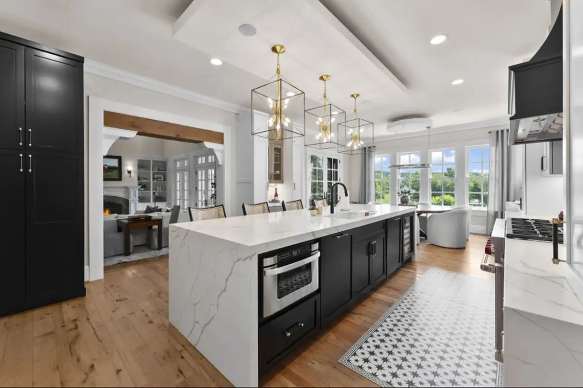 Kitchen with island, Wolf eight-burner range, and three dishwashers of 22364 Wilson Meadows Ln