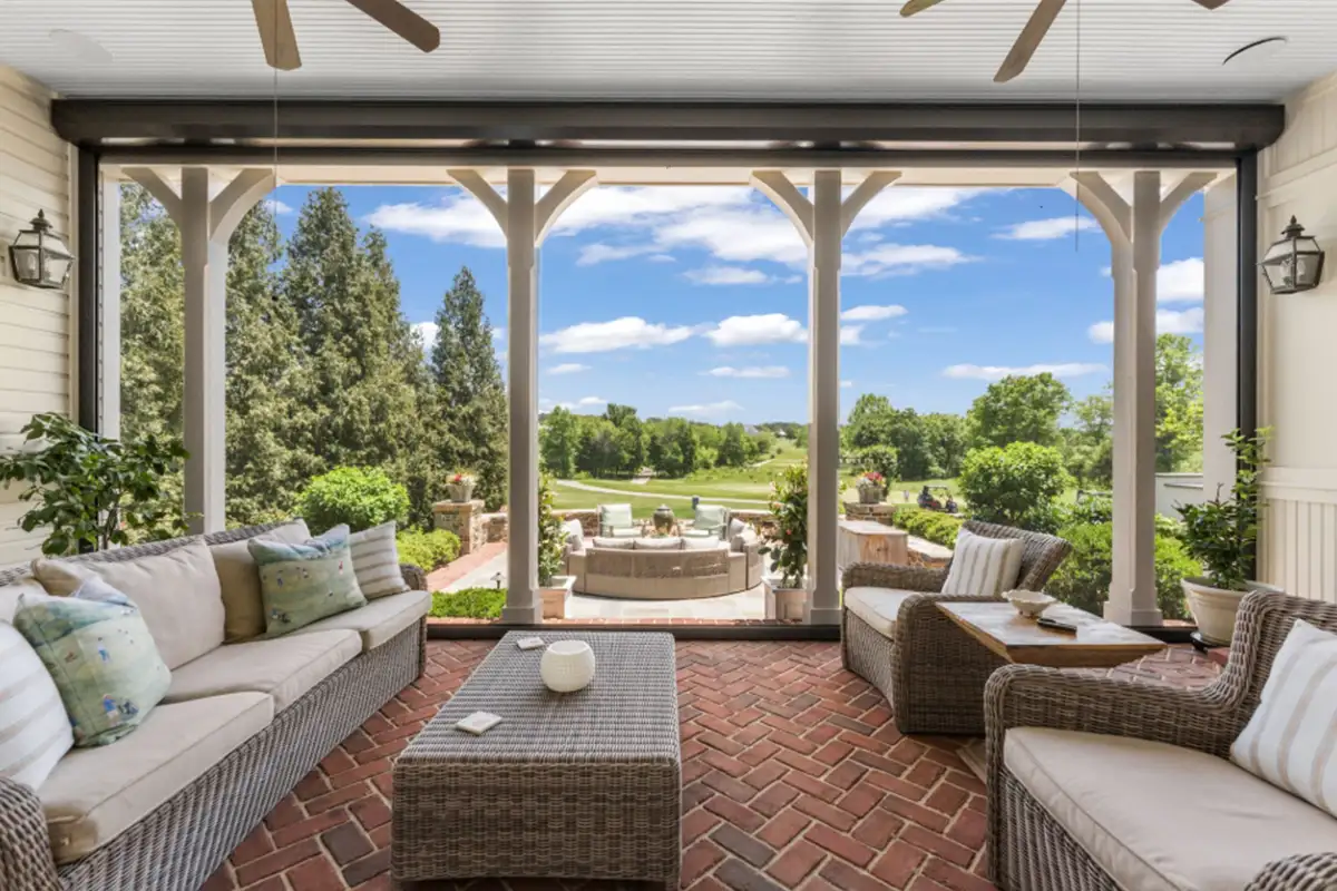 Covered patio with brick flooring, fans, access to outdoor seating, and view of the gold course of 22364 Wilson Meadows Ln