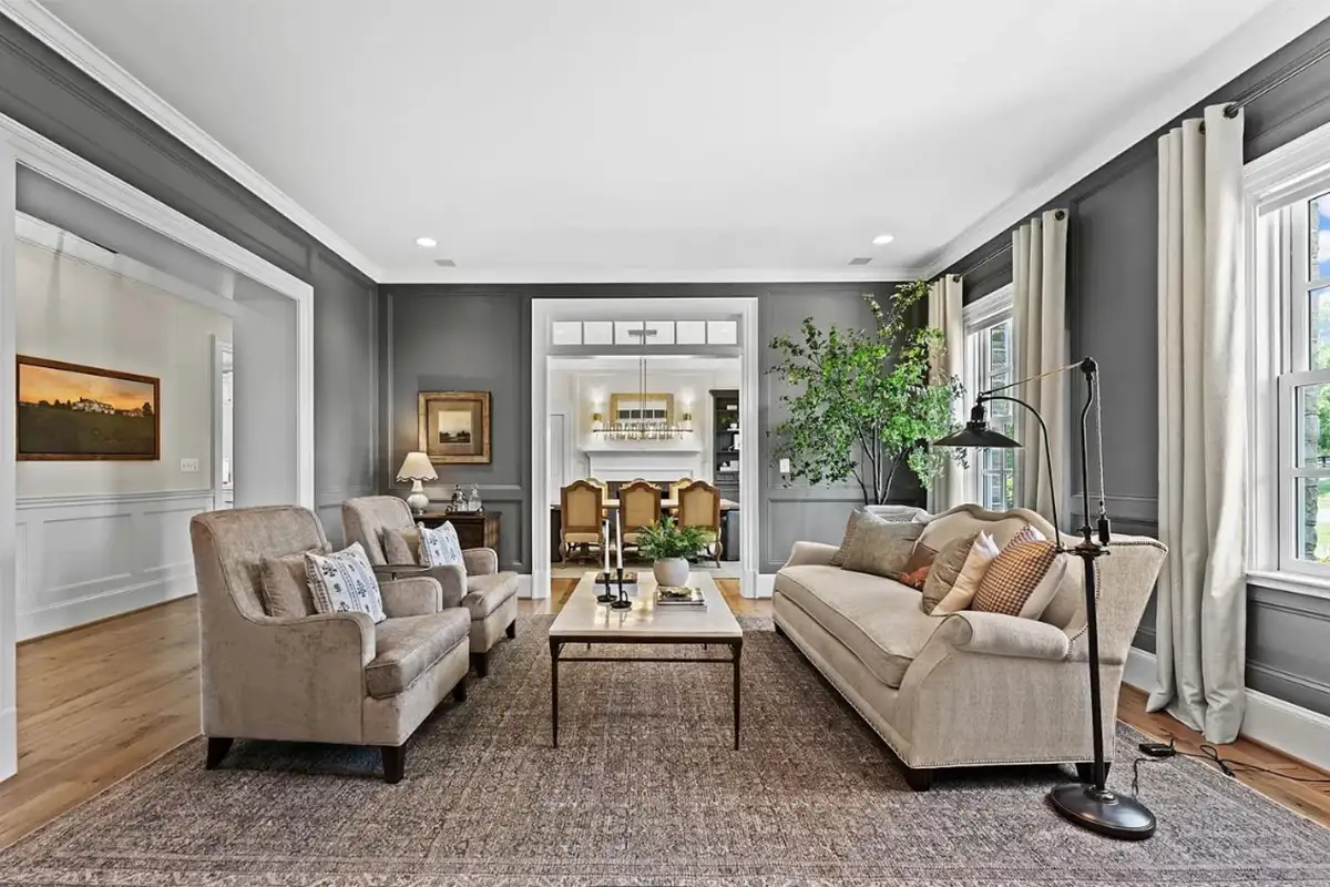 Living room with wide plank oak floors, multiple windows, and wainscoting of 22364 Wilson Meadows Ln