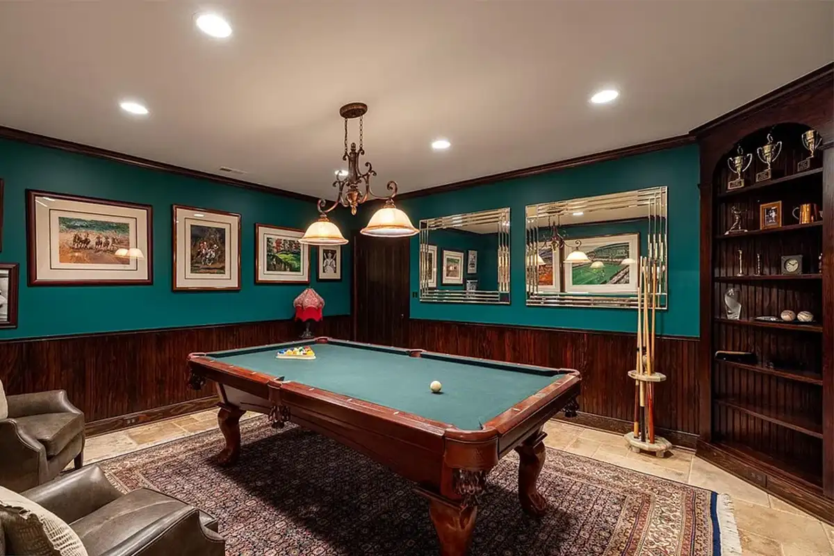 Entertainment room with pool table, built-in bookcase, and wood wainscoting of 2525 Gibson Ct