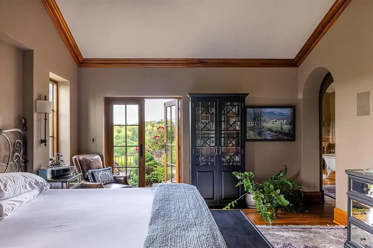 Primary bedroom with outdoor access and arched doorways of 2525 Gibson Ct