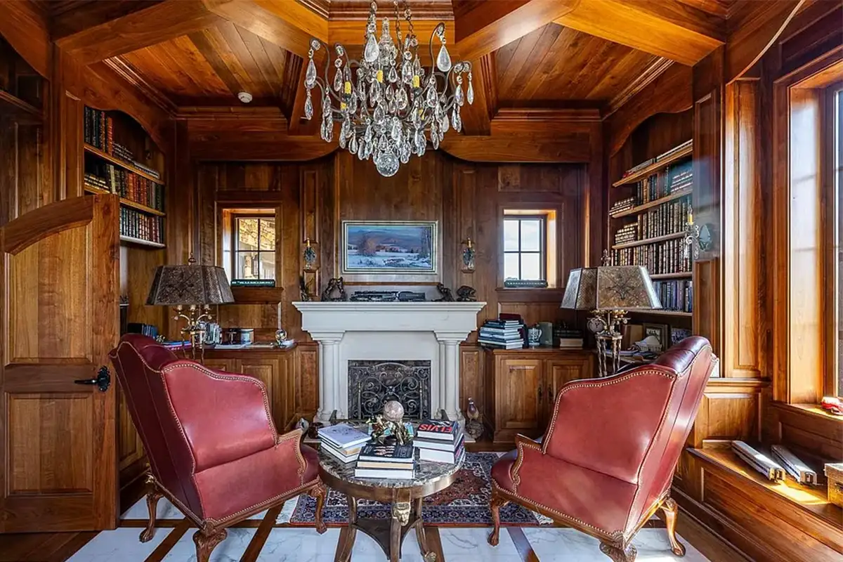 Library with gas fireplace, wood paneling, and built-in bookshelves and reading alcove of 2525 Gibson Ct