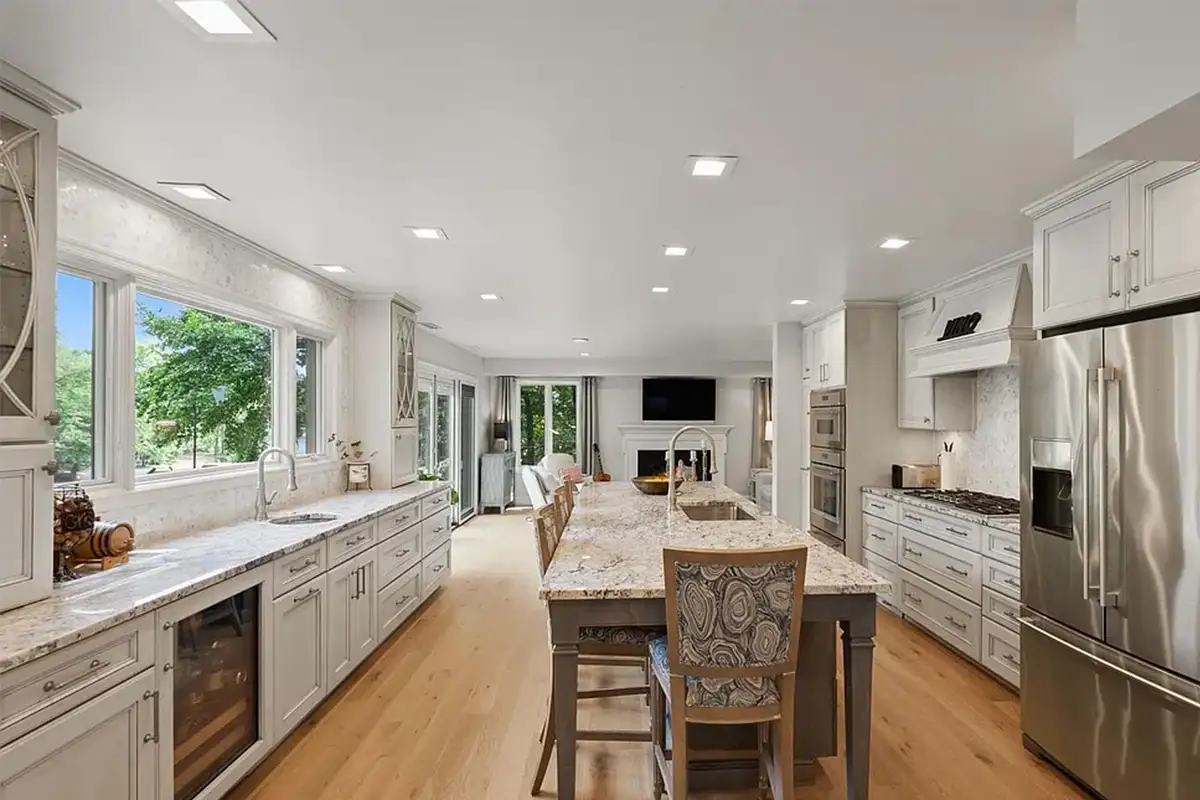 Remodeled kitchen with Italian fixtures, custom cabinets, and large sink window