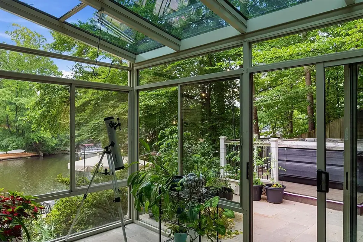 Conservatory/Greenhouse room with concrete floors and glass walls and ceiling