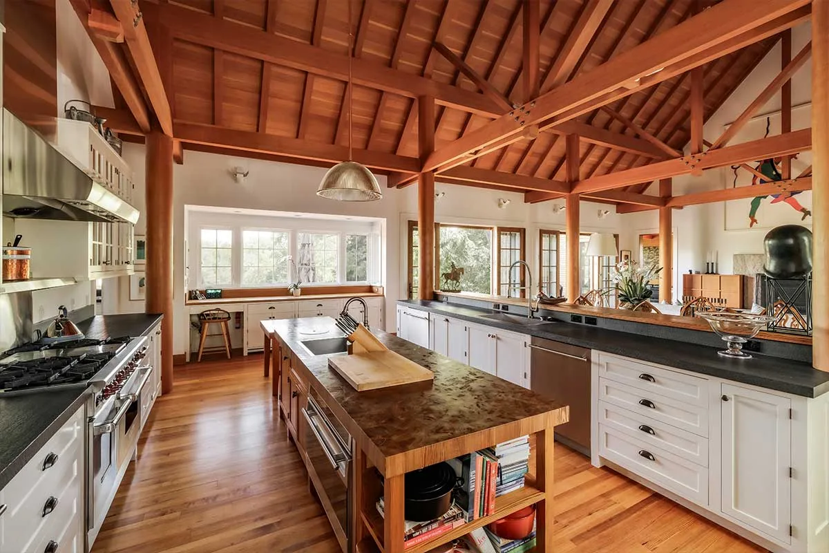farmhouse-style kitchen with vaulted ceilings and wood beams