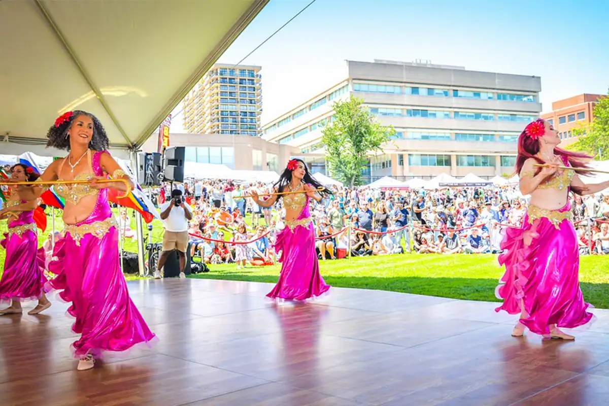 Dancers in pick attire dancing at Around the World Festival