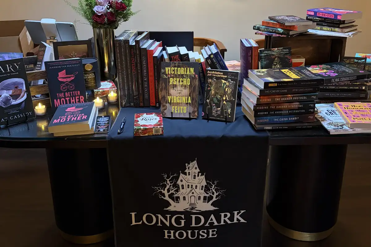 Stacks of horror and sci-fi books on a table at Long Dark House bookstore