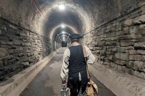 Alexandria Colonial Tours guide Jimmy Meritt leading tour down an abandoned train tunnel
