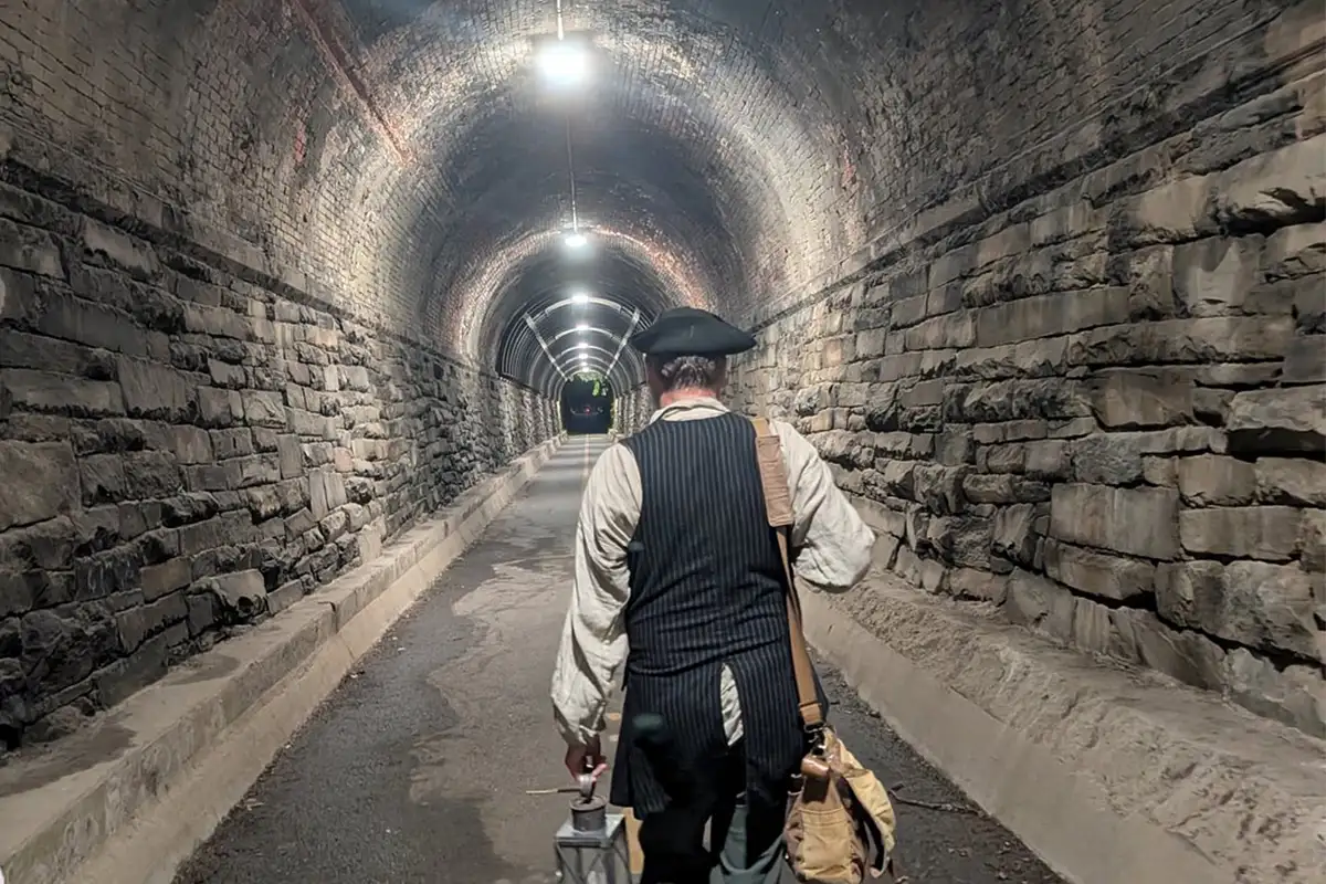 Alexandria Colonial Tours guide Jimmy Meritt leading tour down an abandoned train tunnel
