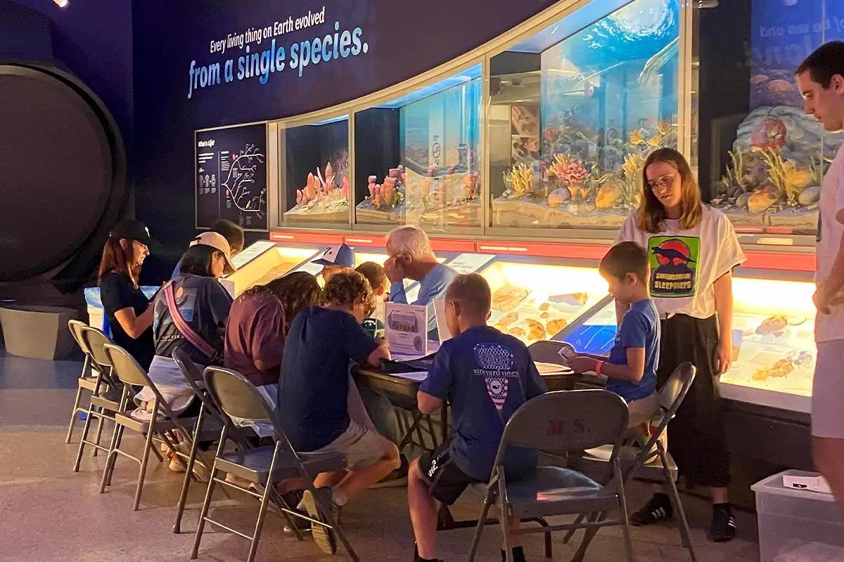 Kids sit at a table doing crafts at a Smithsonian Sleepover