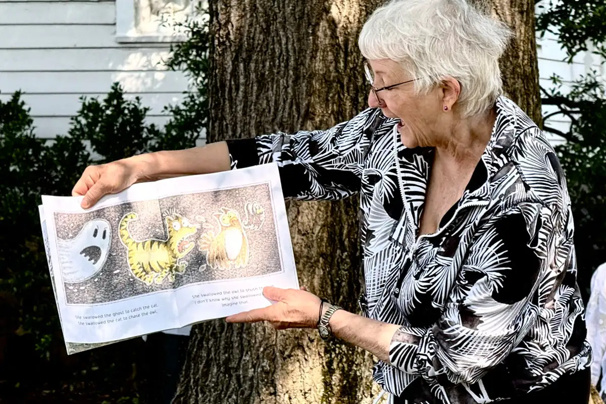 a woman reading a  children's book 