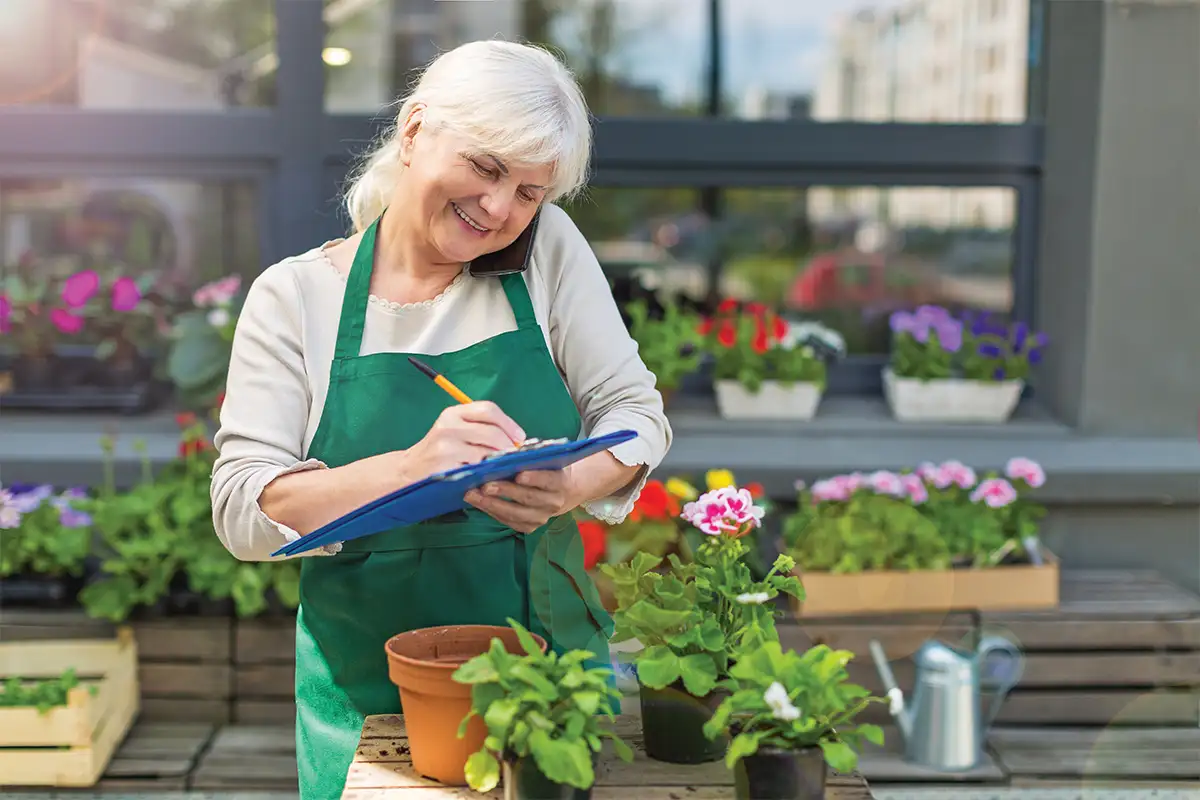 Older woman working at garden center